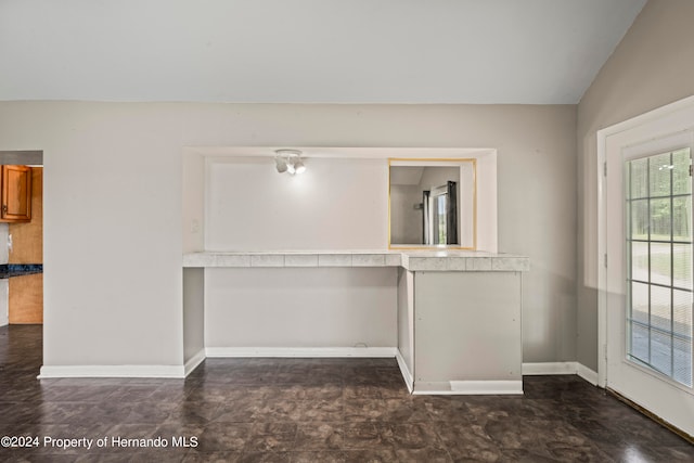 empty room featuring vaulted ceiling