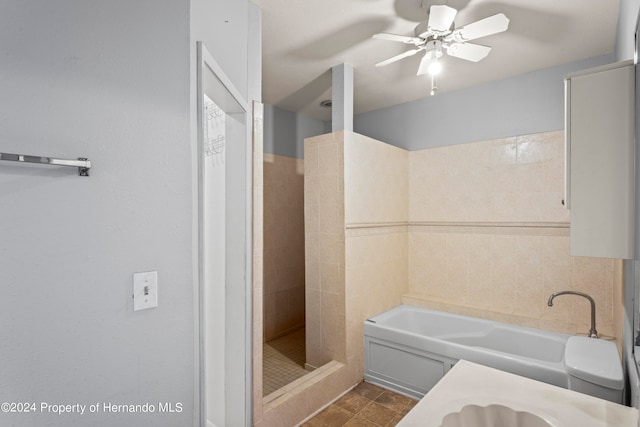 bathroom with tile walls, shower with separate bathtub, ceiling fan, and vanity