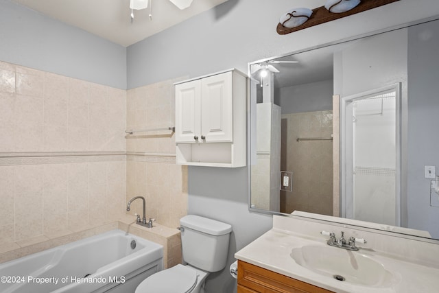 bathroom featuring ceiling fan, a tub to relax in, vanity, and toilet