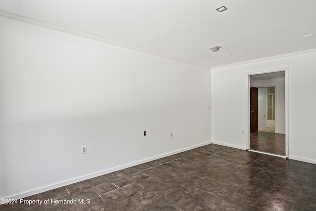 unfurnished room with crown molding