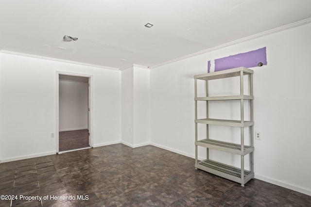 unfurnished room with crown molding