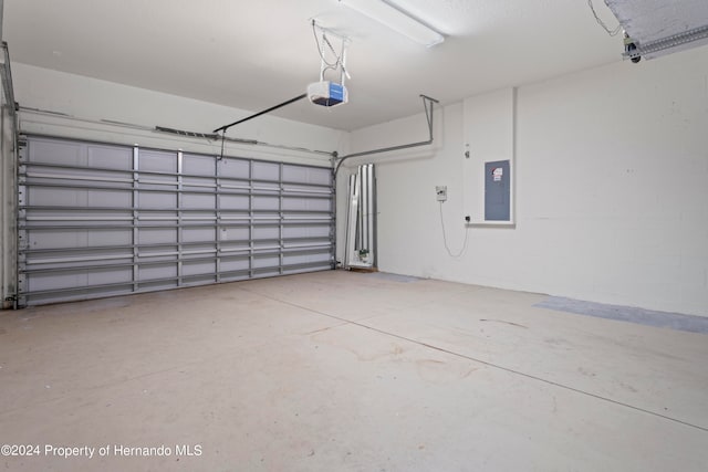 garage with electric panel and a garage door opener