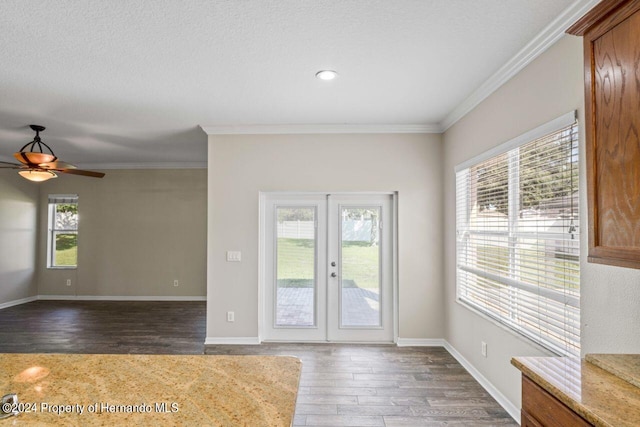 doorway to outside with crown molding, dark wood-type flooring, a wealth of natural light, and french doors