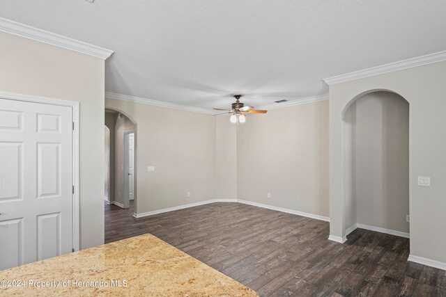 spare room featuring ceiling fan, dark hardwood / wood-style flooring, and ornamental molding