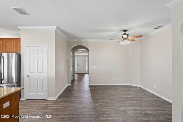 empty room with a textured ceiling, ceiling fan, dark hardwood / wood-style floors, and ornamental molding