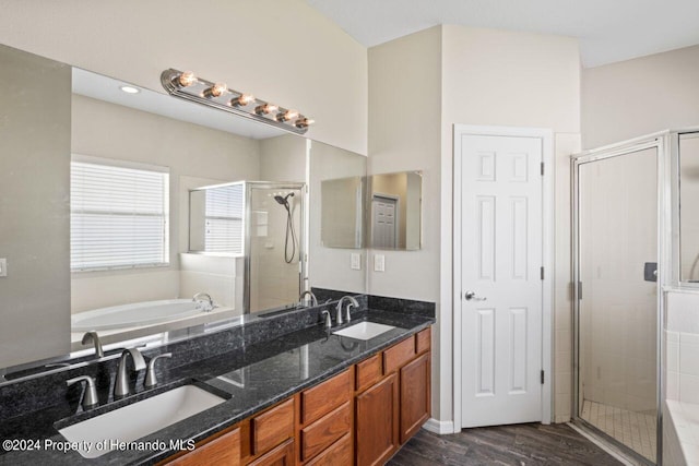 bathroom with plus walk in shower, vanity, and hardwood / wood-style flooring