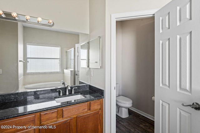 full bathroom with wood-type flooring, vanity, shower with separate bathtub, and toilet