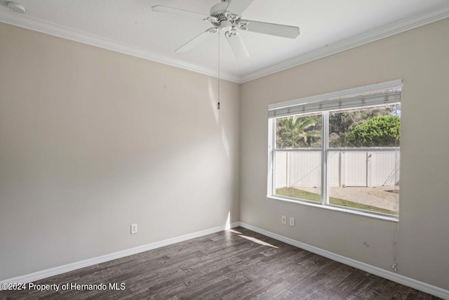 empty room with ornamental molding, ceiling fan, and dark wood-type flooring