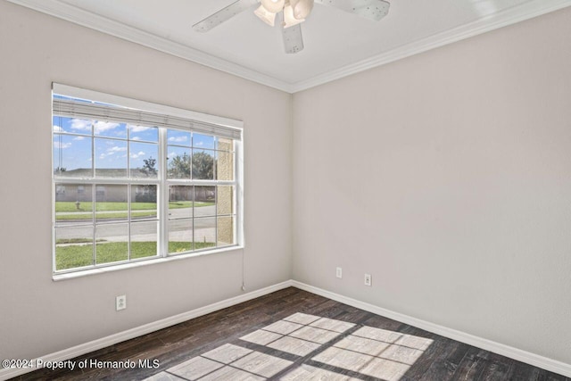 empty room featuring dark hardwood / wood-style flooring, ceiling fan, and crown molding