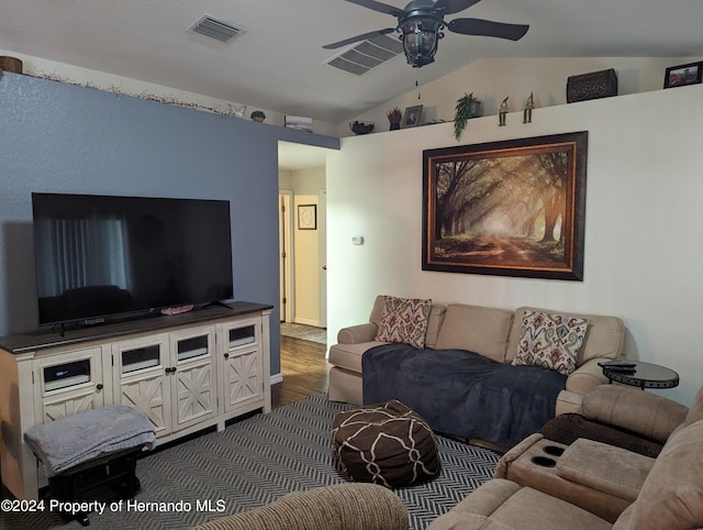 living room featuring hardwood / wood-style floors, ceiling fan, and vaulted ceiling