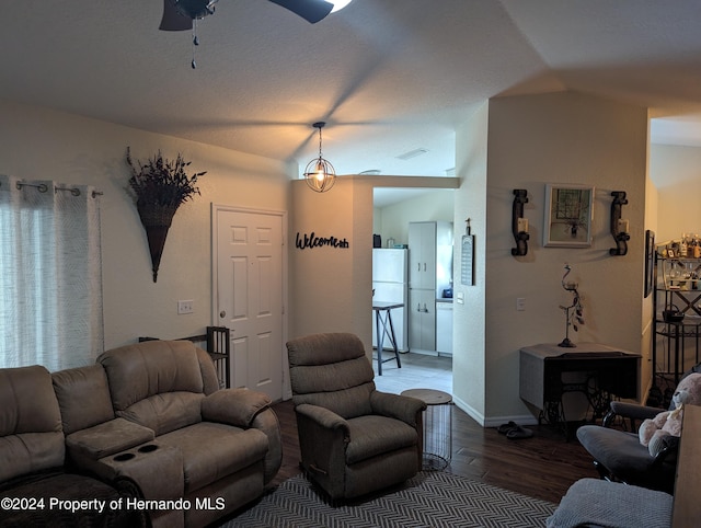 living room with lofted ceiling, ceiling fan, and wood-type flooring