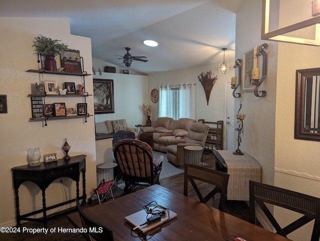 living room with dark hardwood / wood-style flooring, vaulted ceiling, and ceiling fan