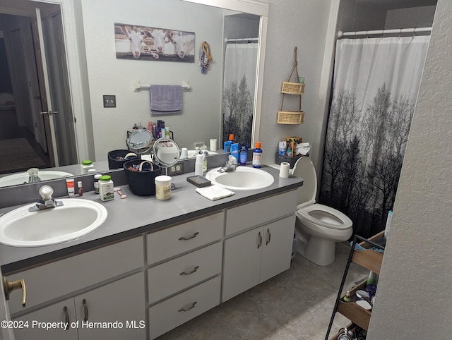 bathroom with toilet, a shower with curtain, vanity, and tile patterned floors