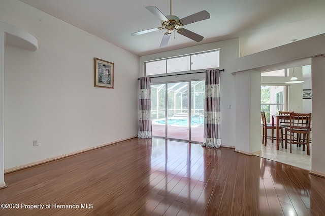 empty room with wood-type flooring and ceiling fan