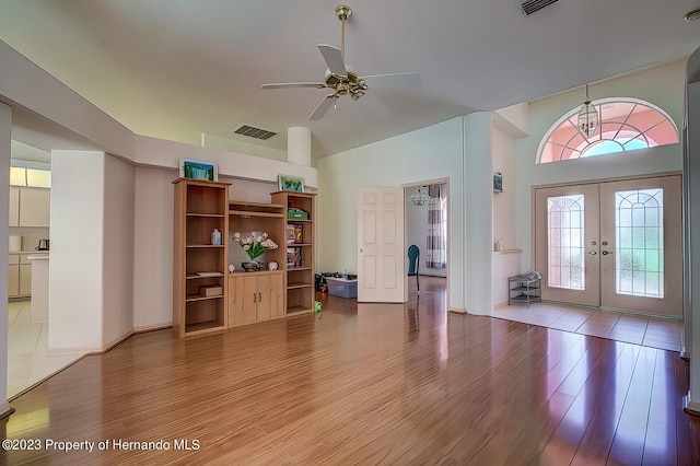 foyer with ceiling fan, wood-type flooring, and french doors