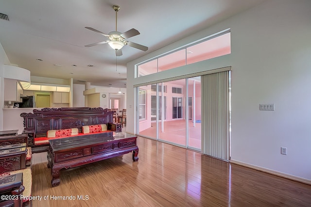 miscellaneous room featuring ceiling fan and light hardwood / wood-style flooring