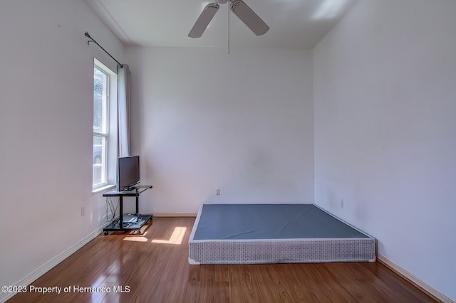 unfurnished bedroom featuring hardwood / wood-style flooring and ceiling fan