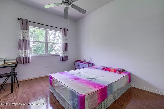 bedroom featuring wood-type flooring, ceiling fan, and vaulted ceiling