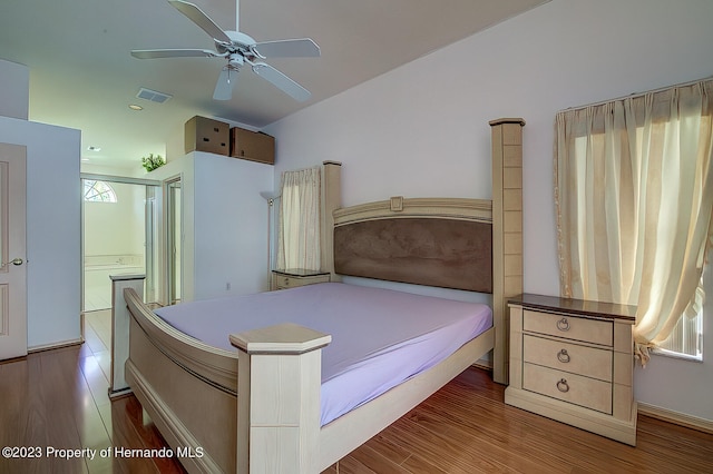 bedroom with ceiling fan and dark hardwood / wood-style flooring