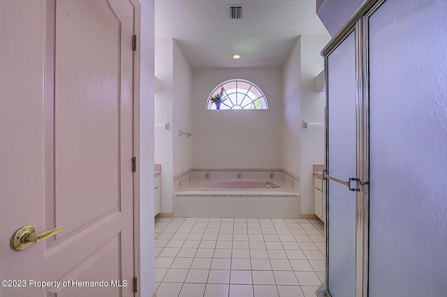 bathroom with a bathtub and tile patterned floors