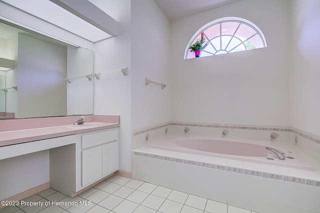 bathroom featuring vanity, tiled bath, and tile patterned floors