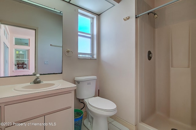 bathroom with walk in shower, toilet, vanity, and tile patterned floors