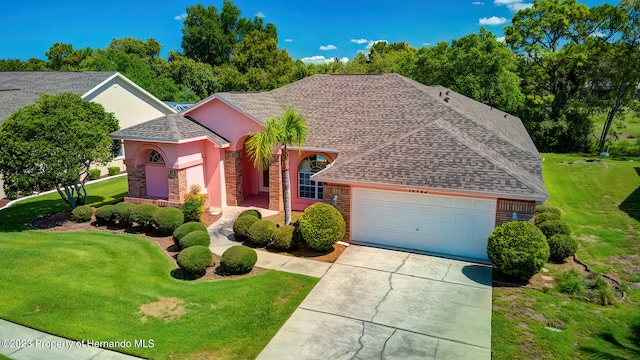 view of front of home featuring a garage and a front yard