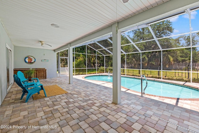 view of pool featuring ceiling fan, a patio, a lanai, and pool water feature