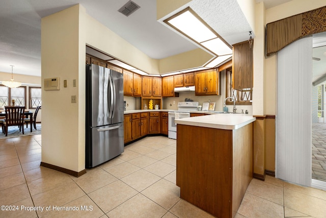 kitchen with a wealth of natural light, kitchen peninsula, white electric range, and stainless steel refrigerator