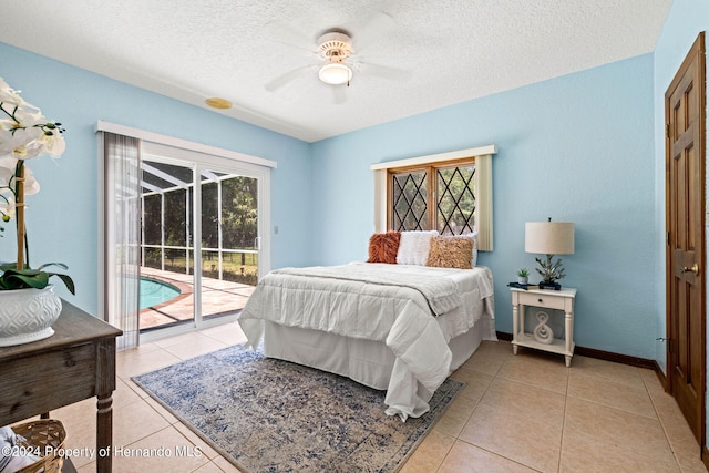 tiled bedroom featuring ceiling fan, access to exterior, multiple windows, and a textured ceiling