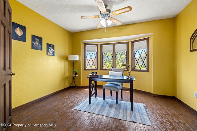 office space featuring ceiling fan, a textured ceiling, and dark hardwood / wood-style flooring