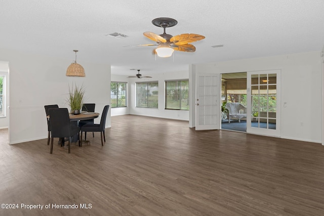 dining area with a textured ceiling, ceiling fan, dark hardwood / wood-style flooring, and french doors