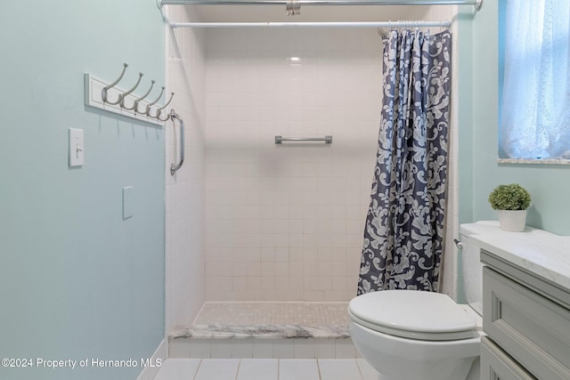 bathroom featuring toilet, tile patterned floors, walk in shower, and vanity