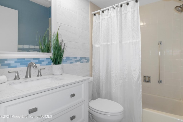 full bathroom featuring toilet, vanity, and shower / bath combo with shower curtain