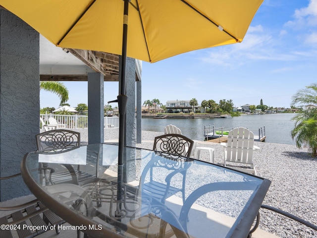 view of patio / terrace featuring a boat dock and a water view