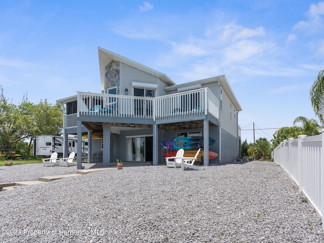 back of property featuring a wooden deck