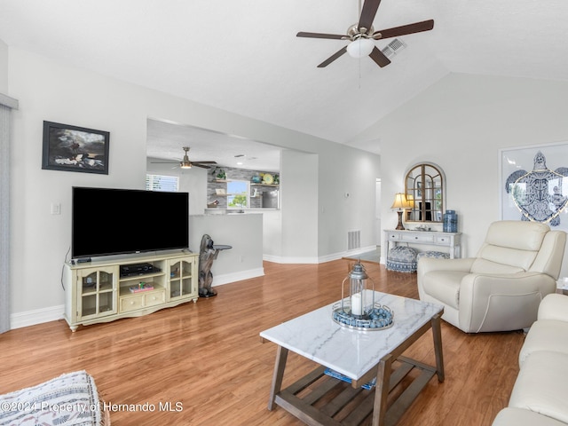 living room featuring ceiling fan, hardwood / wood-style floors, and vaulted ceiling