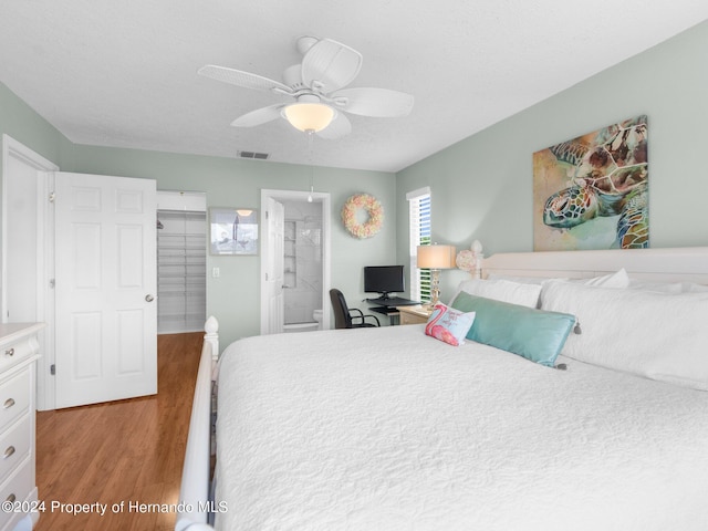 bedroom with ensuite bath, ceiling fan, and light wood-type flooring