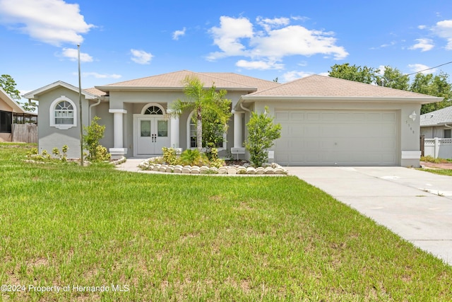 view of front of house with a garage and a front lawn