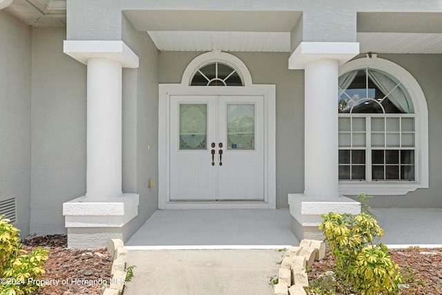 view of exterior entry featuring french doors