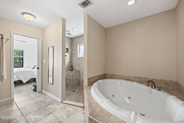 bathroom featuring tile patterned floors and separate shower and tub