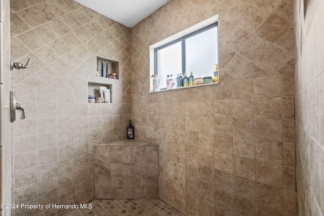 bathroom with tiled shower