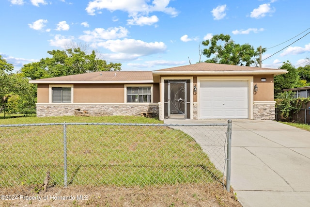 view of front of property featuring a garage and a front yard