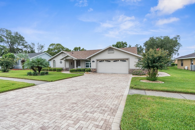 single story home featuring a garage, central AC, and a front yard