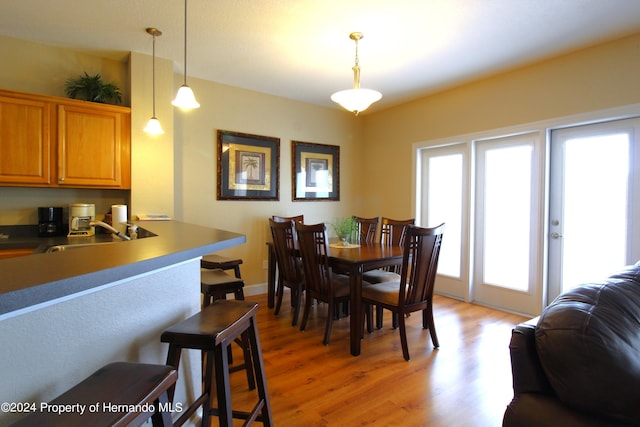 dining room featuring hardwood / wood-style flooring and sink