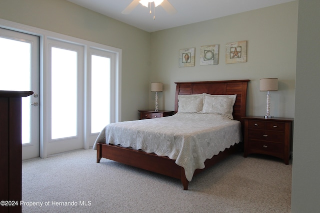 bedroom featuring light colored carpet and ceiling fan