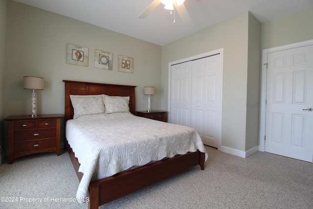 carpeted bedroom featuring a closet and ceiling fan