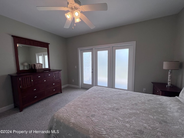 carpeted bedroom featuring access to outside and ceiling fan