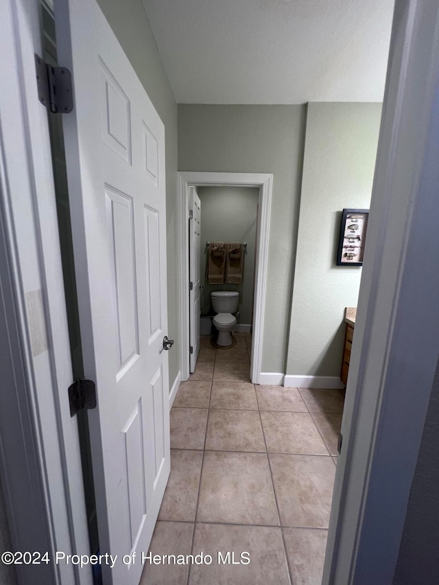 bathroom featuring vanity, tile patterned floors, and toilet