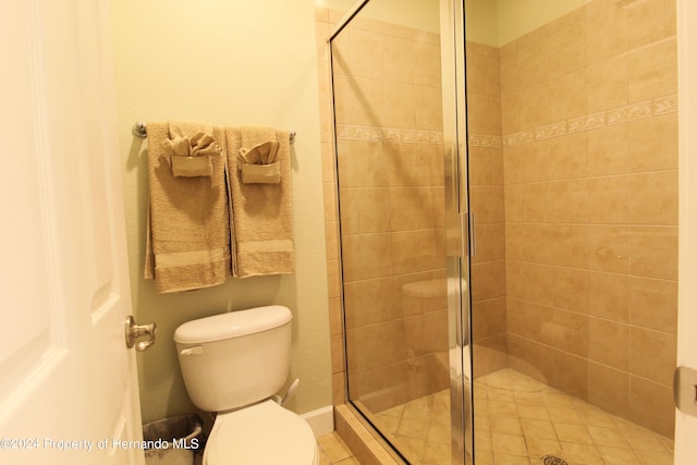 bathroom featuring toilet and an enclosed shower